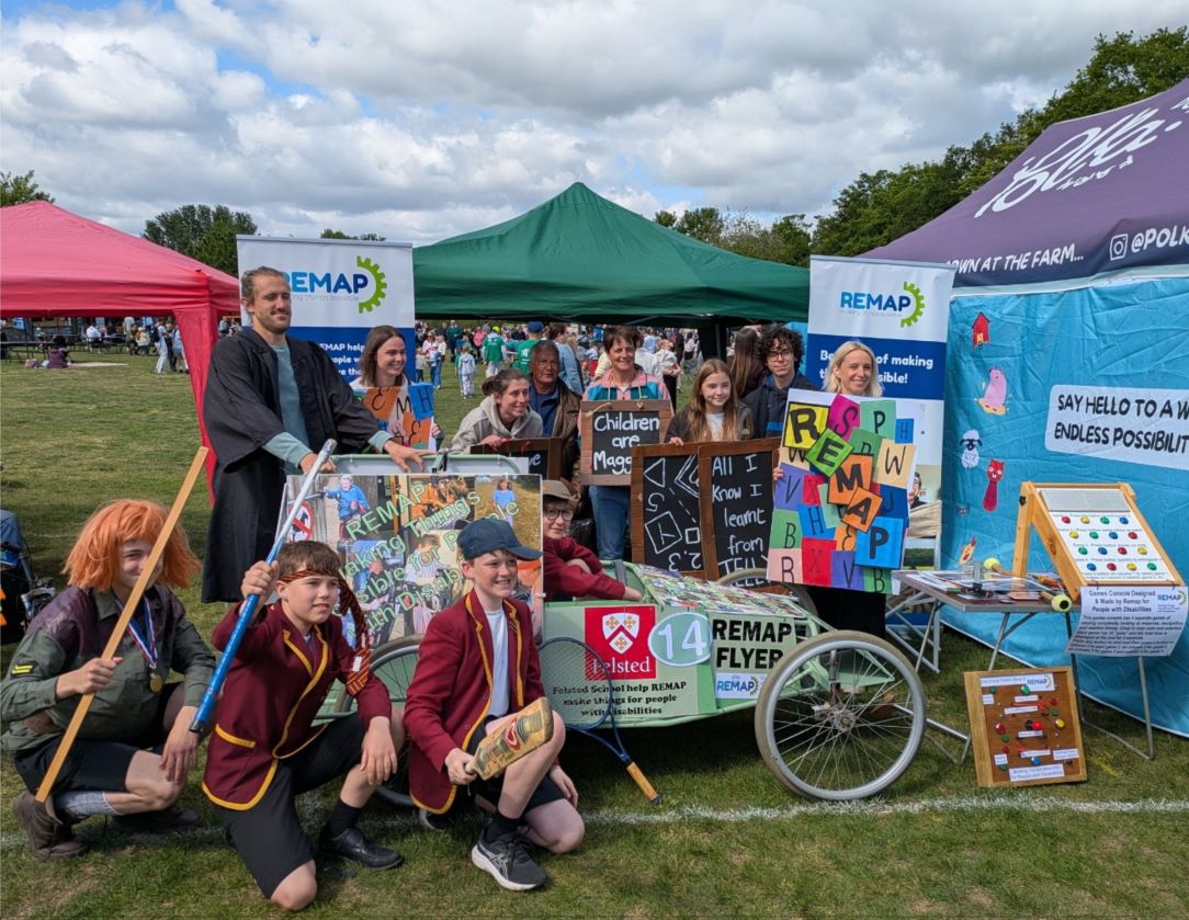Students from Felsted School with their soapbox car in front of the REMAP stand at the Billericay Soapbox Derby