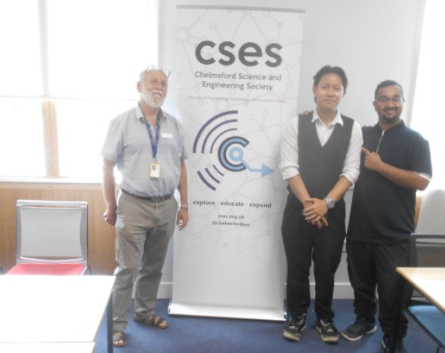 David, Jayce and Zayeem standing next to the CSES banner and smiling